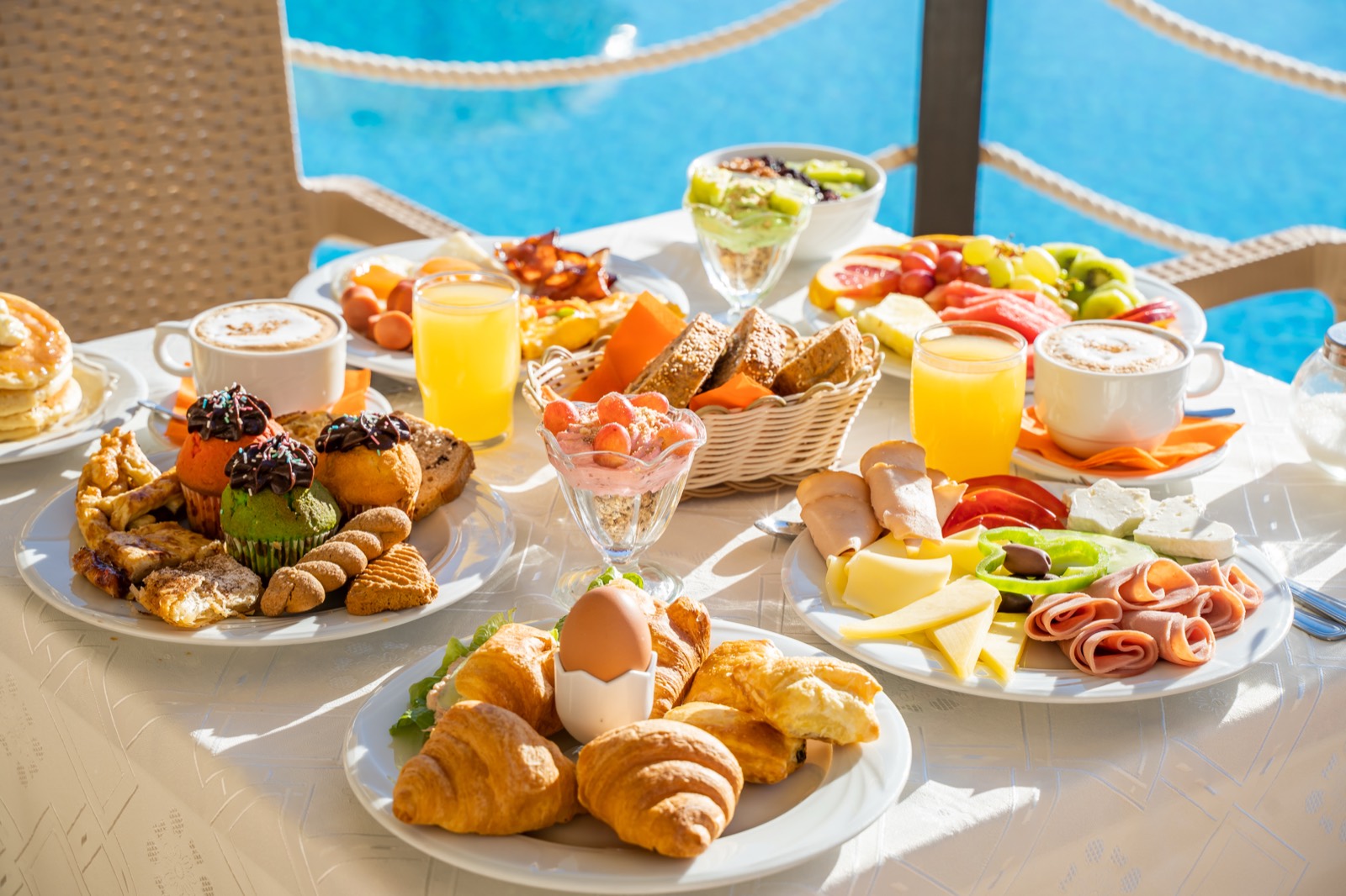 Full Greek breakfast spread served beside the pool