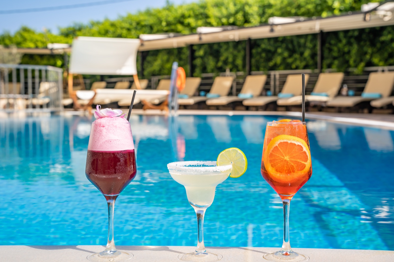 Colourful cocktails served at the edge of the pool